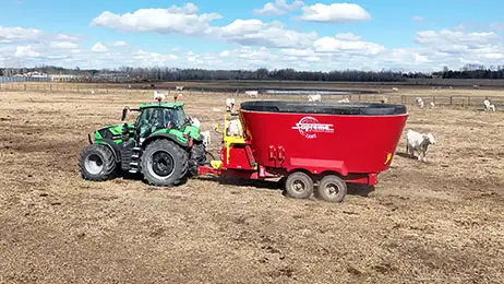 Deutz tractor pulling a mixer feeding livestock